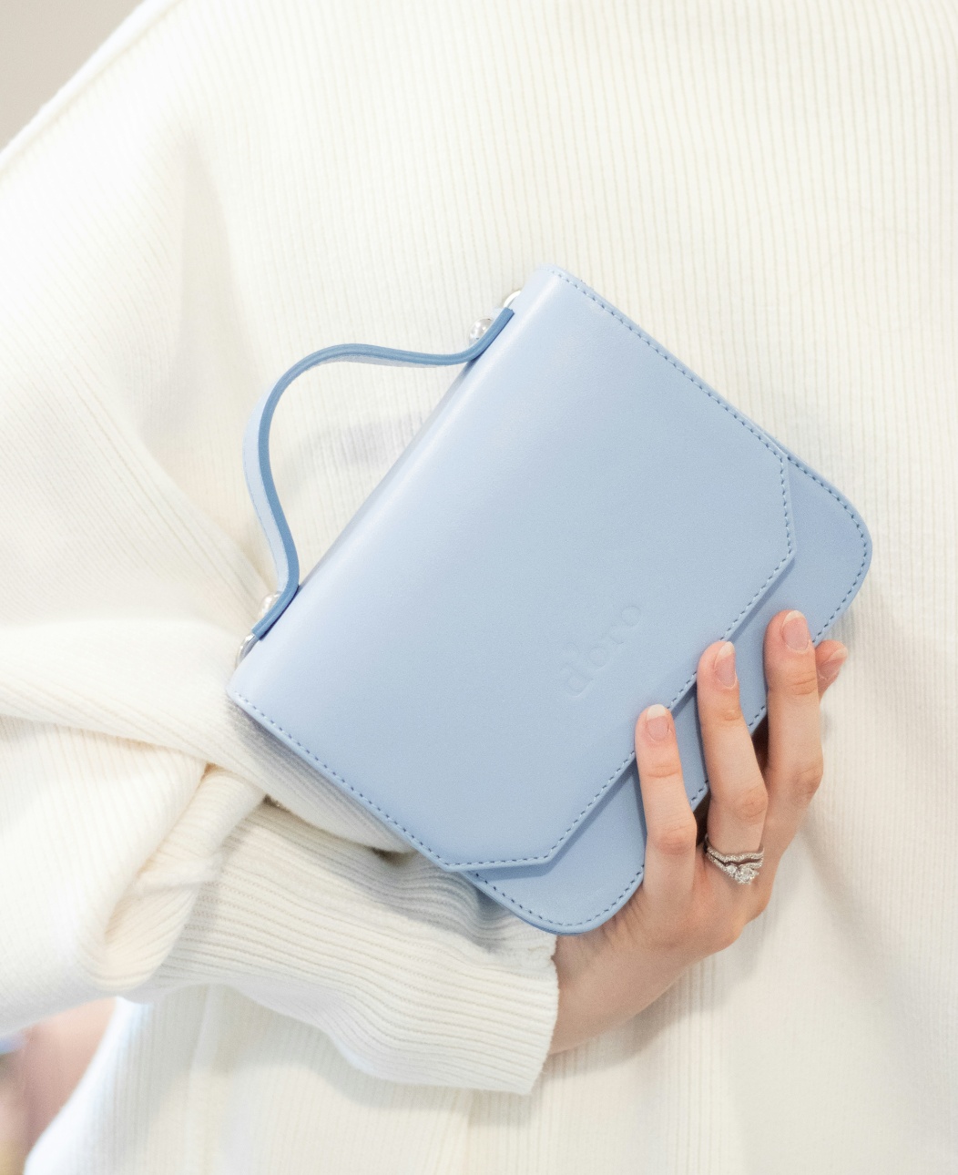 Bolso azul en mano